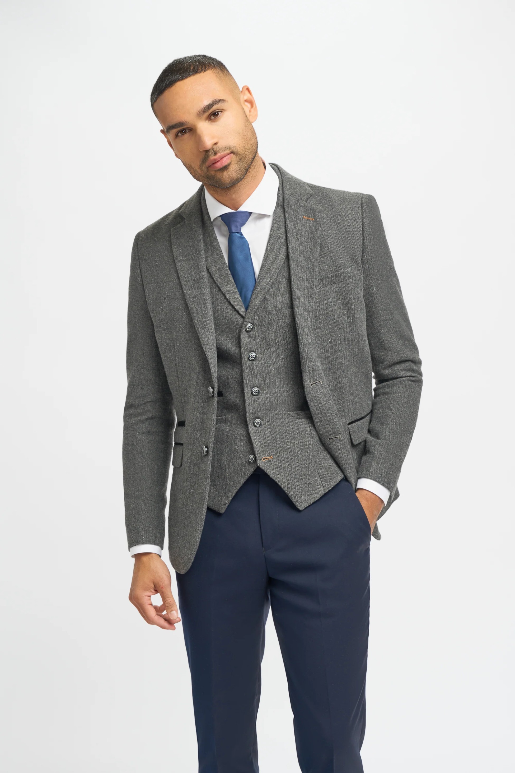 Men's Grey Herringbone Tweed Jacket and Waistcoat with Slim Fit Navy Blue Trousers