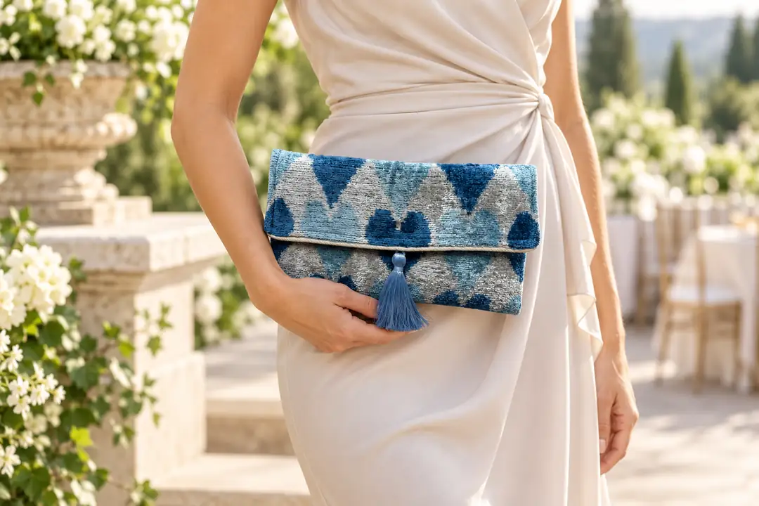 Blue ikat velvet clutch styled with a white wedding guest dress