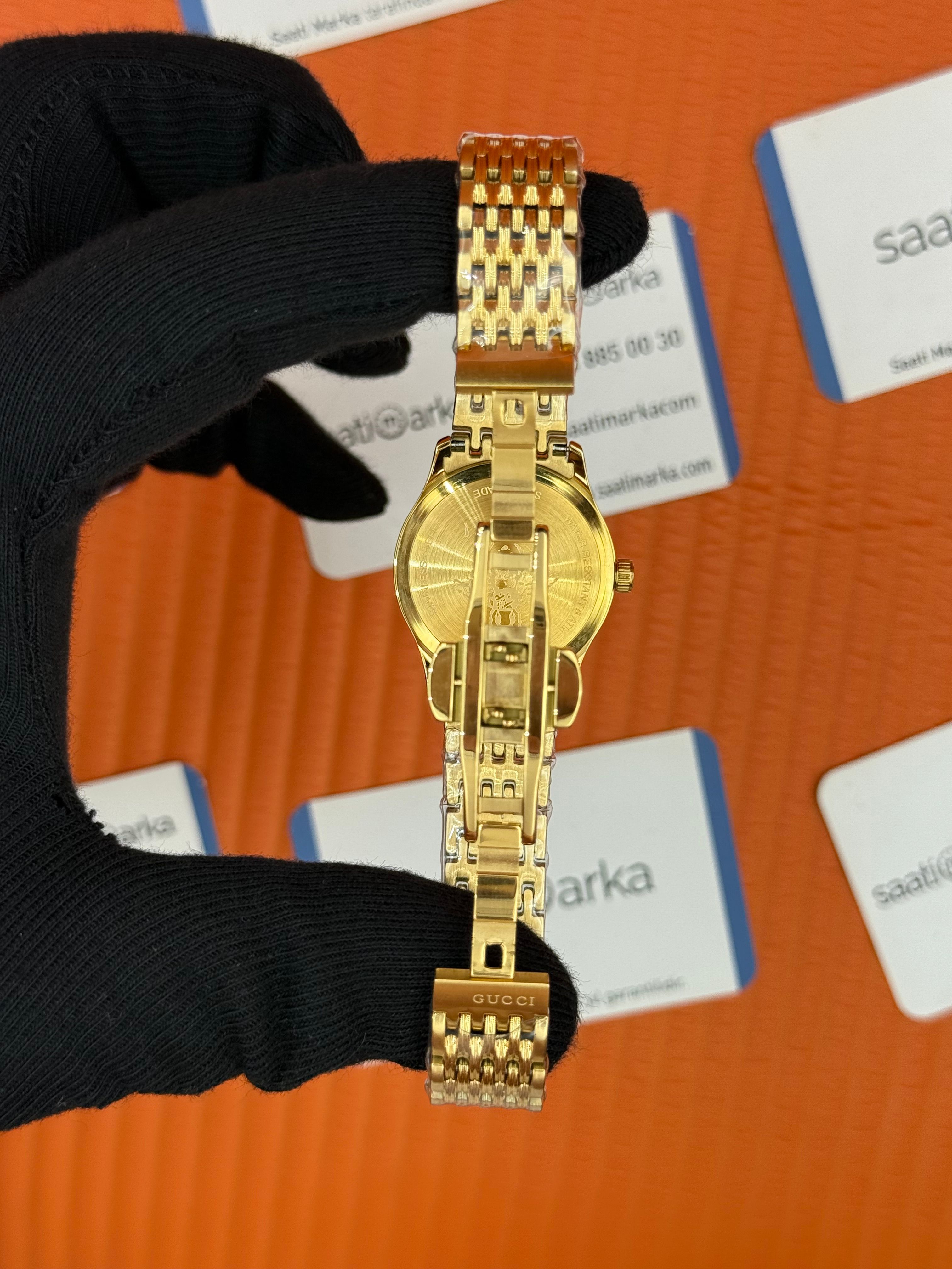 GUCCI şampanya kadran gold kasa kordon kadın kol saati