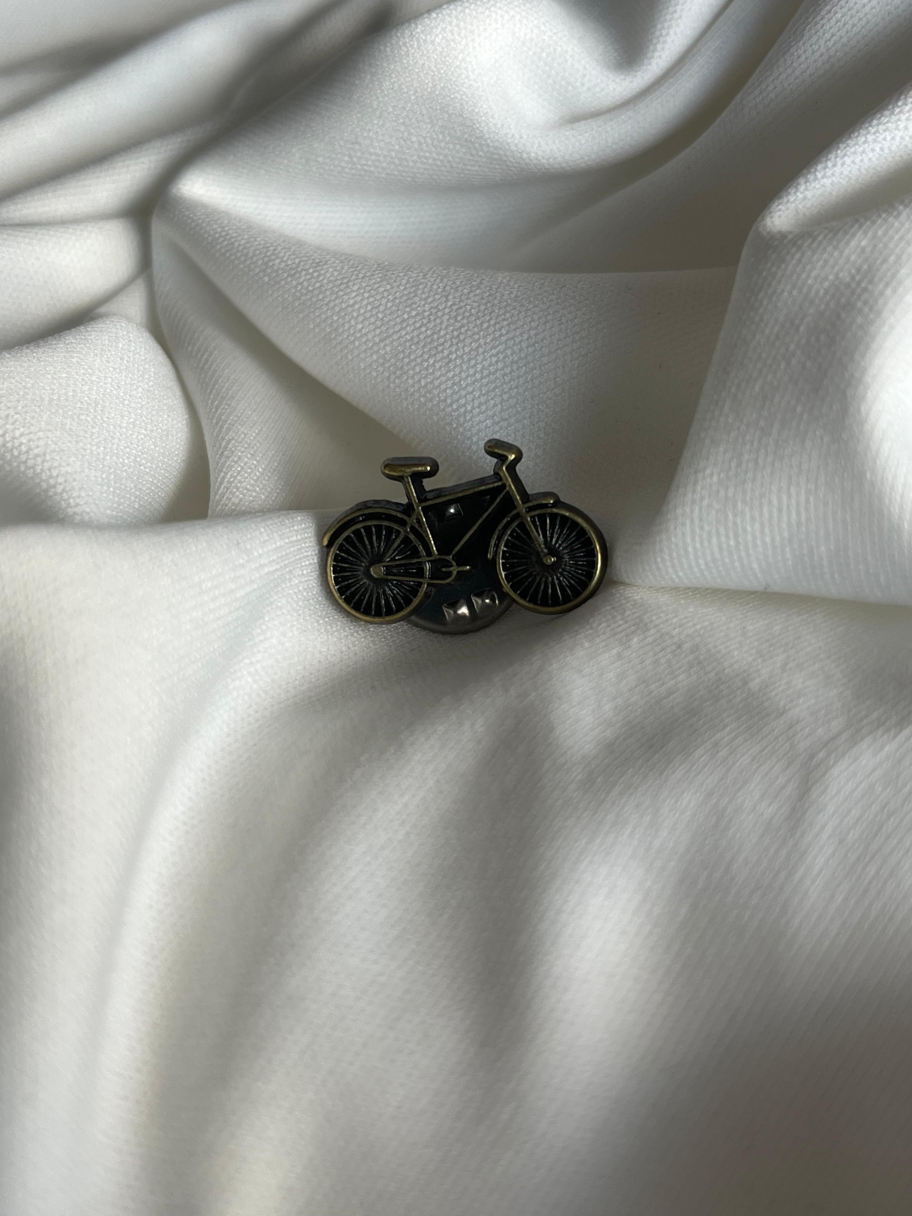 Tiny lapel brooch.