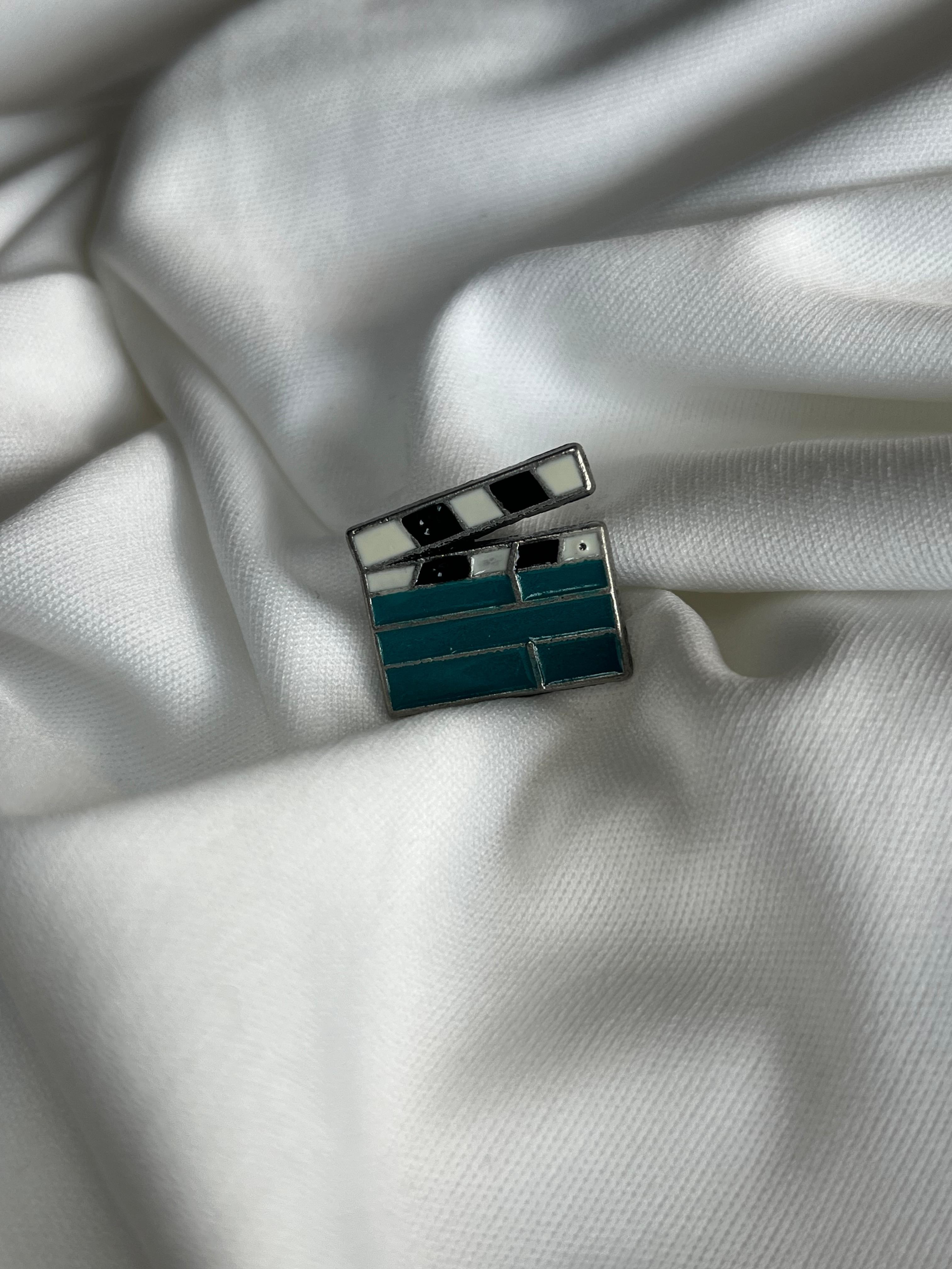 Tiny lapel brooch.