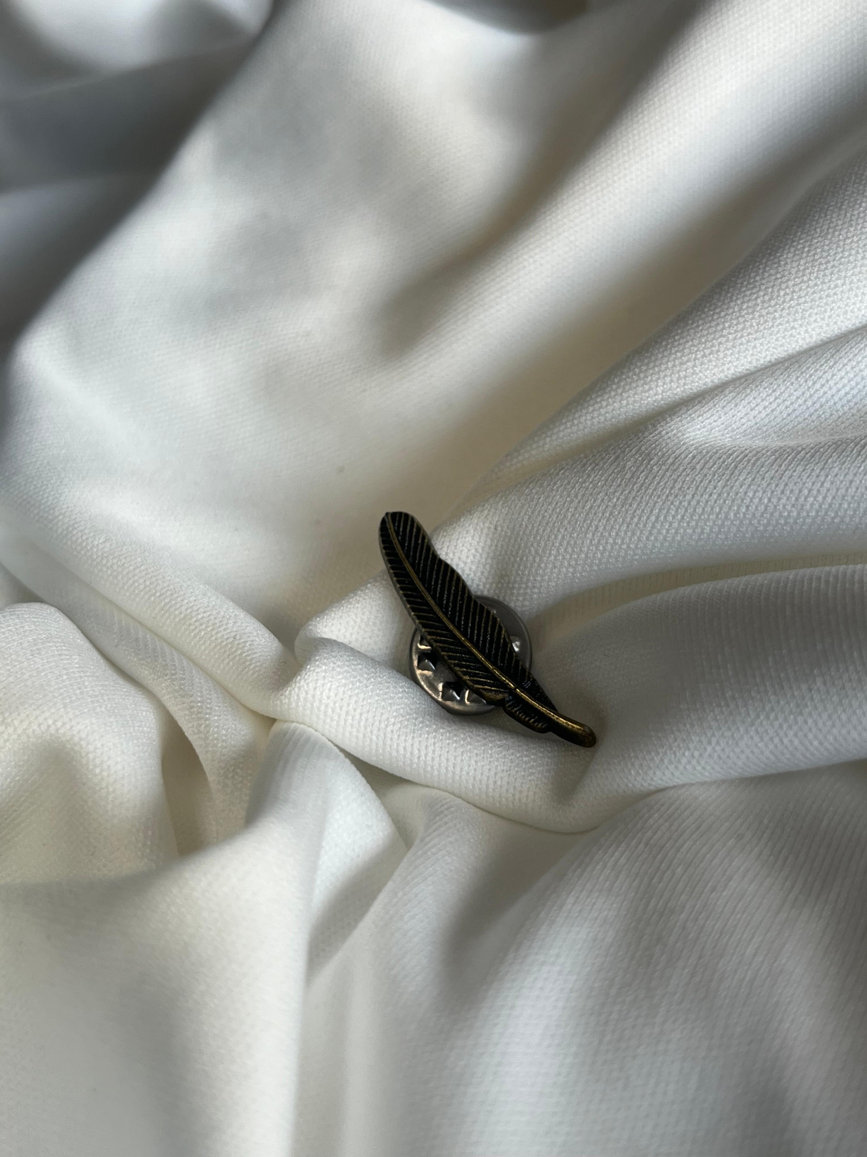 Tiny lapel brooch.