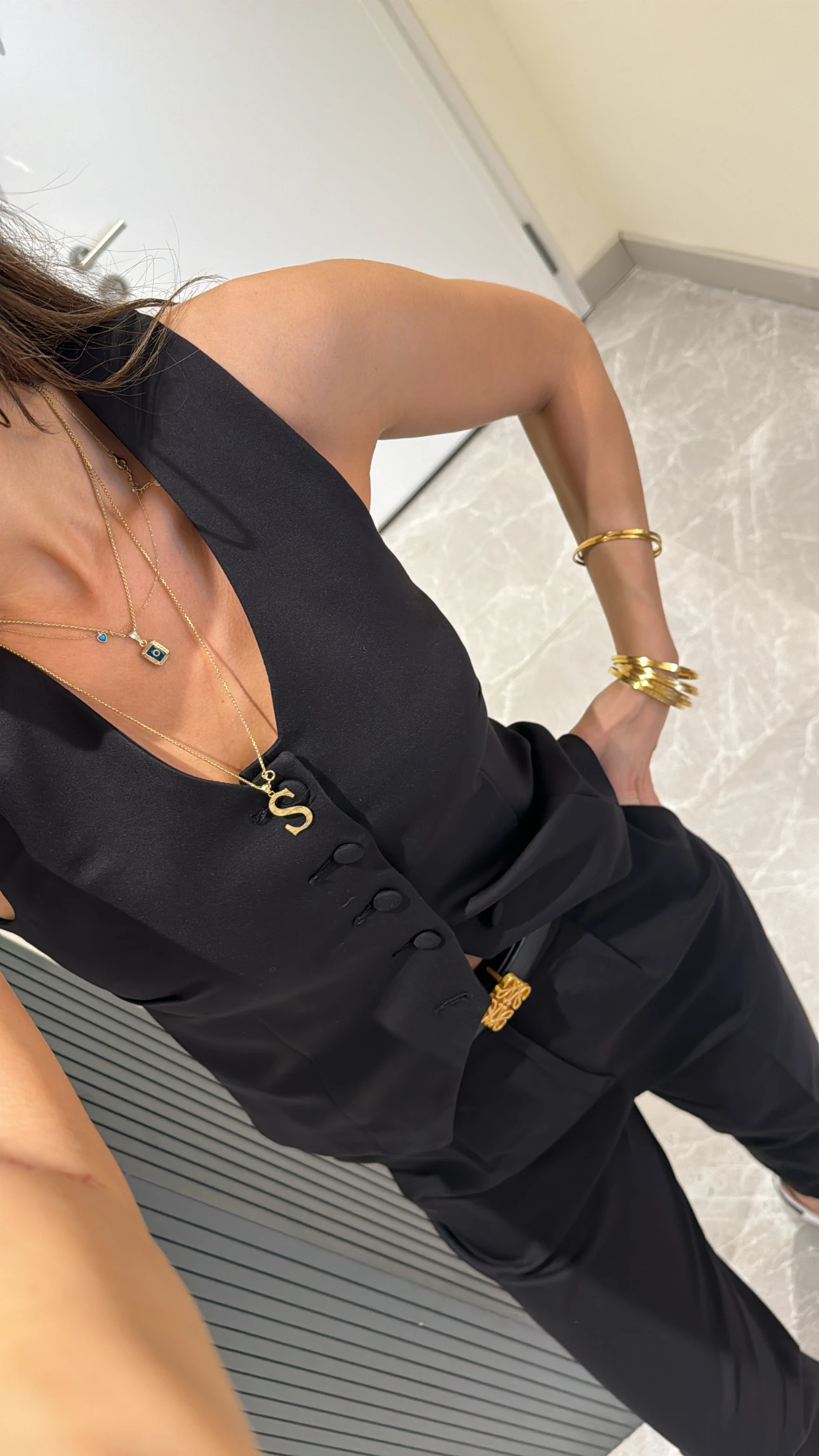 black button-detailed vest