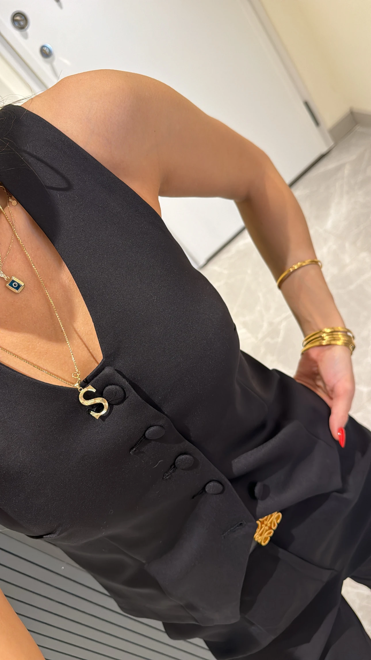 black button-detailed vest