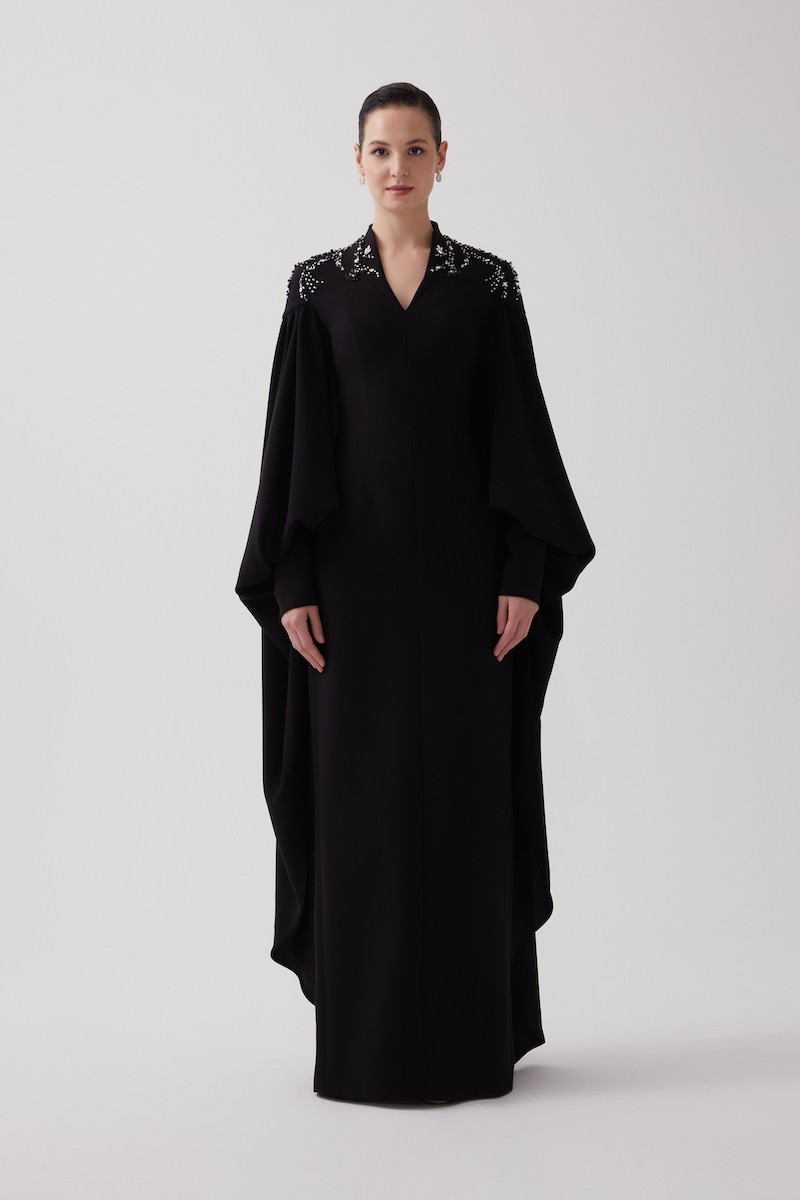 R106 - High V-Neckline, Yoke, Padded Shoulders, Cuffed Sleeves, Batwing Cape, Hand-Embroidered Shoulder Details, Back Slit, Straight Cut, Full-Length Dress