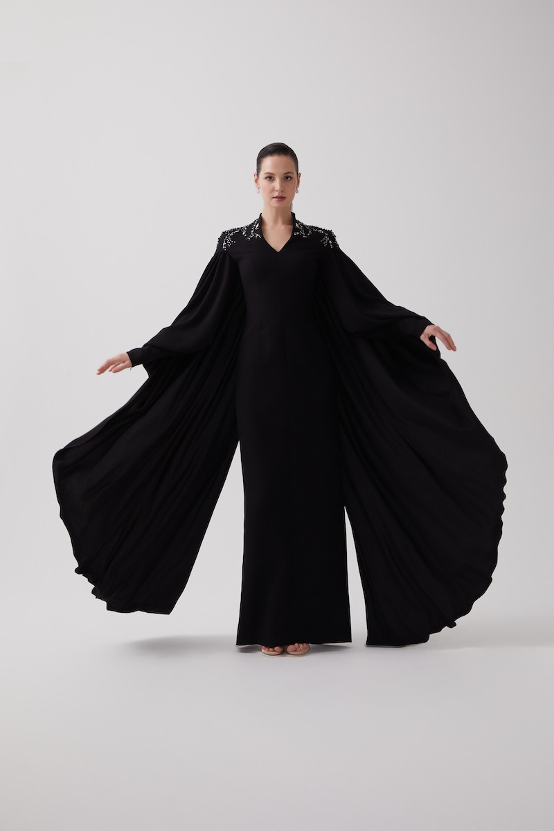 R106 - High V-Neckline, Yoke, Padded Shoulders, Cuffed Sleeves, Batwing Cape, Hand-Embroidered Shoulder Details, Back Slit, Straight Cut, Full-Length Dress