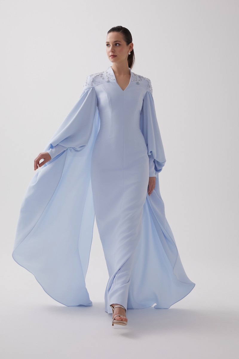 R106 - High V-Neckline, Yoke, Padded Shoulders, Cuffed Sleeves, Batwing Cape, Hand-Embroidered Shoulder Details, Back Slit, Straight Cut, Full-Length Dress