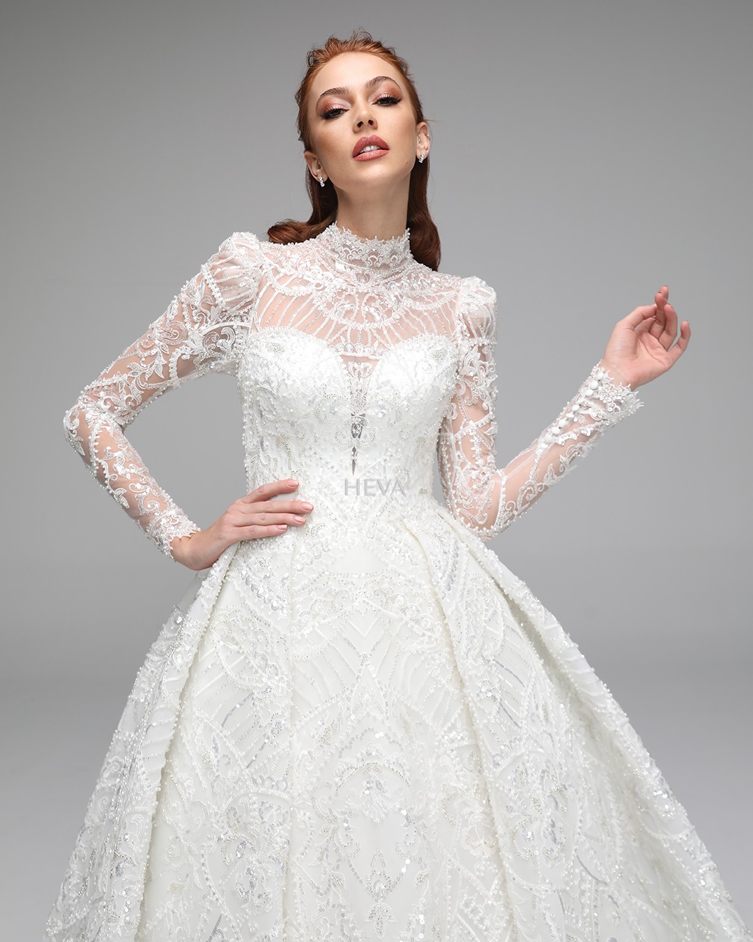 HV22001 - Long-Sleeved Wedding Gown with Pleated Skirt, Train, Corset Bodice, and Hand-Embroidered Beadwork