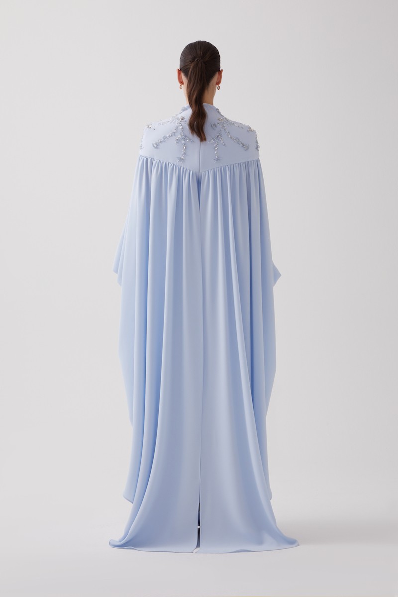 R106 - High V-Neckline, Yoke, Padded Shoulders, Cuffed Sleeves, Batwing Cape, Hand-Embroidered Shoulder Details, Back Slit, Straight Cut, Full-Length Dress