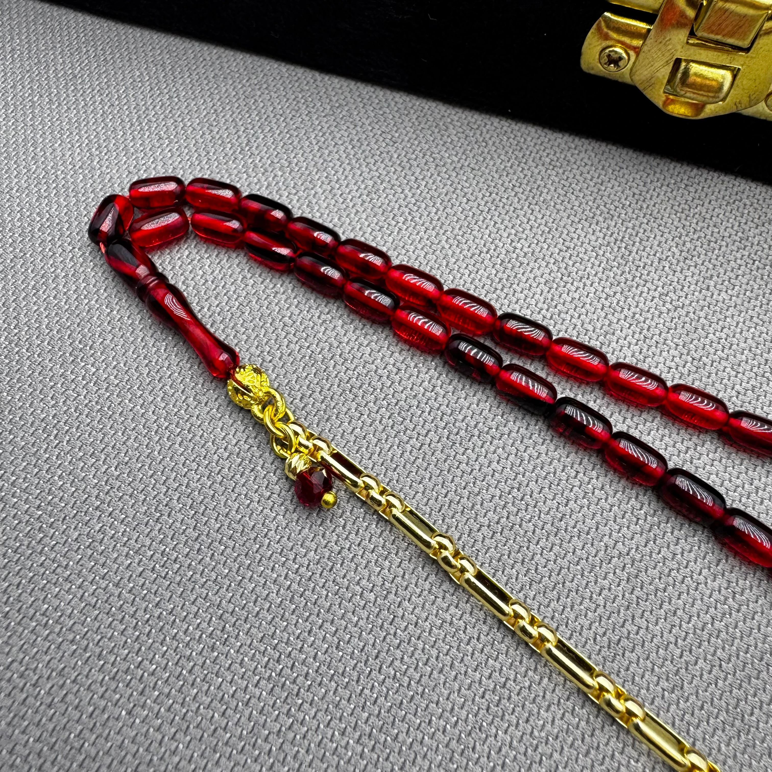 Özel Dizayn Pirinç Püsküllü Kırmızı Hareli Bilek Boy Ateş Kehribar Tespih