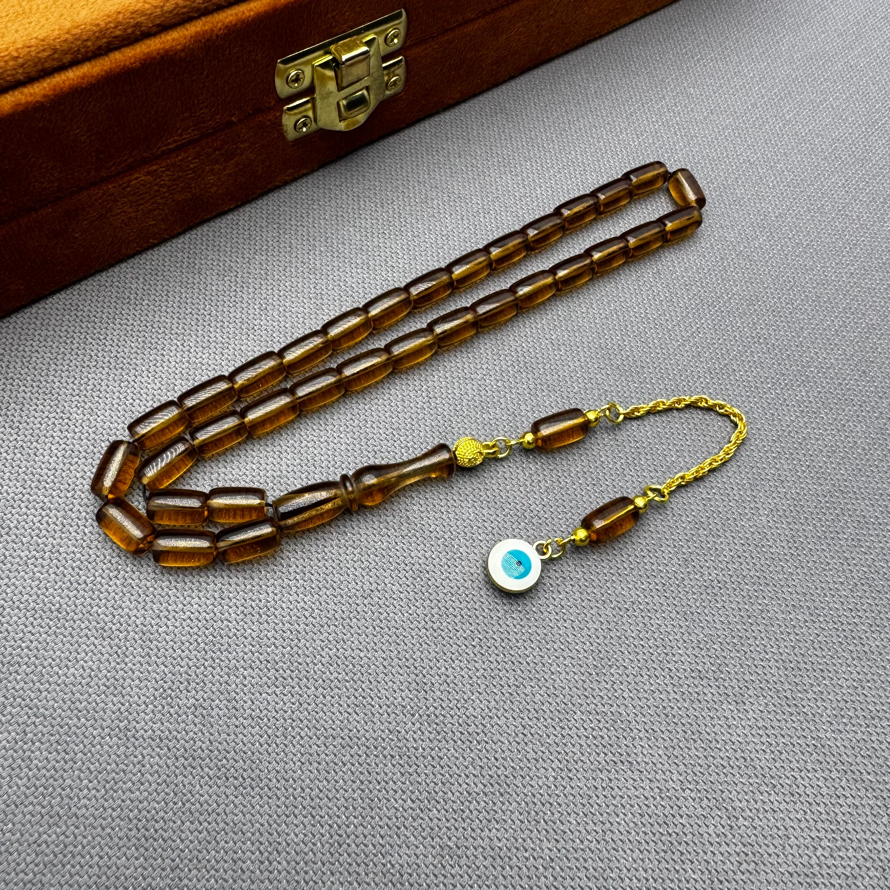 Nazar Boncuğu Detaylı Pirinç Püsküllü Bilek Boy Kapsül Kesim Bal Rengi Uçak Camı Tespih