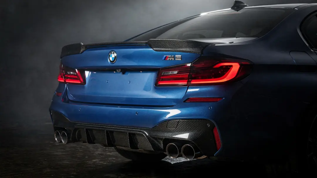 The carbon diffuser frames the quad exhaust tips; the ducktail spoiler finishes the rear.
