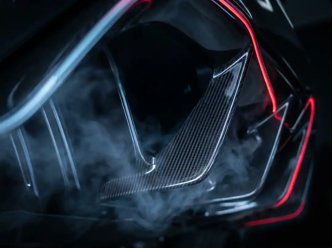 Carbon diffuser fins evacuate the underbody air in a controlled way, sucking the car downward.