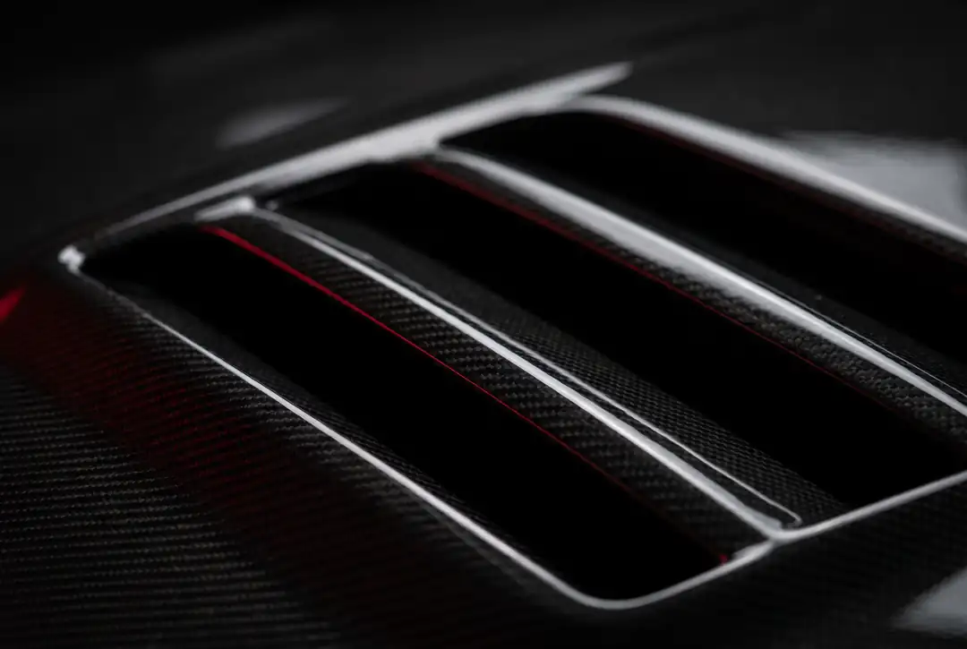 Integrated hood louvers help hot engine-bay air escape — function and form in the same part.