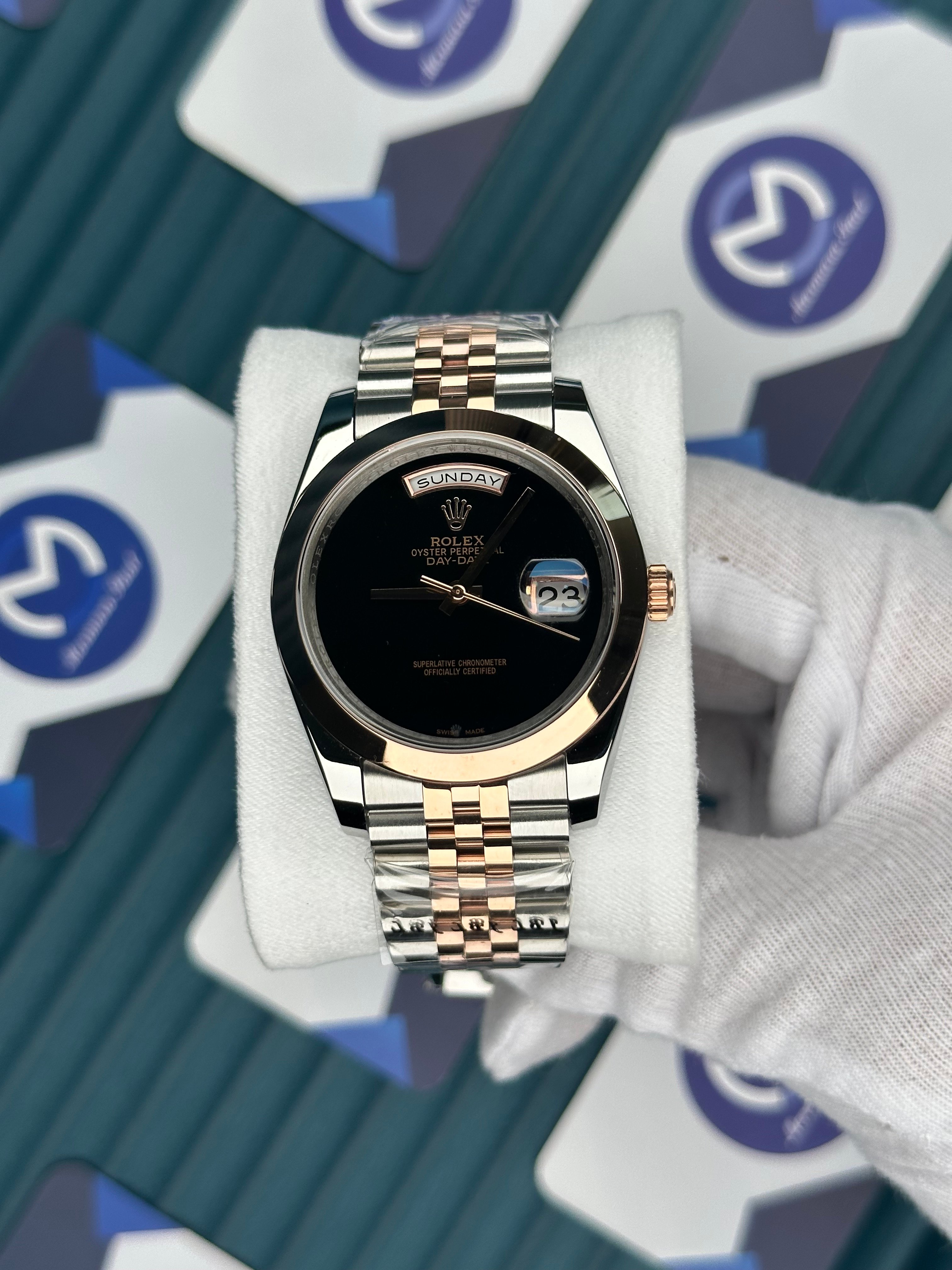 ROLEX DAY-DATE BLACK DIAL NO INDEX OVAL BEZEL ROSE-SILVER JUBILE