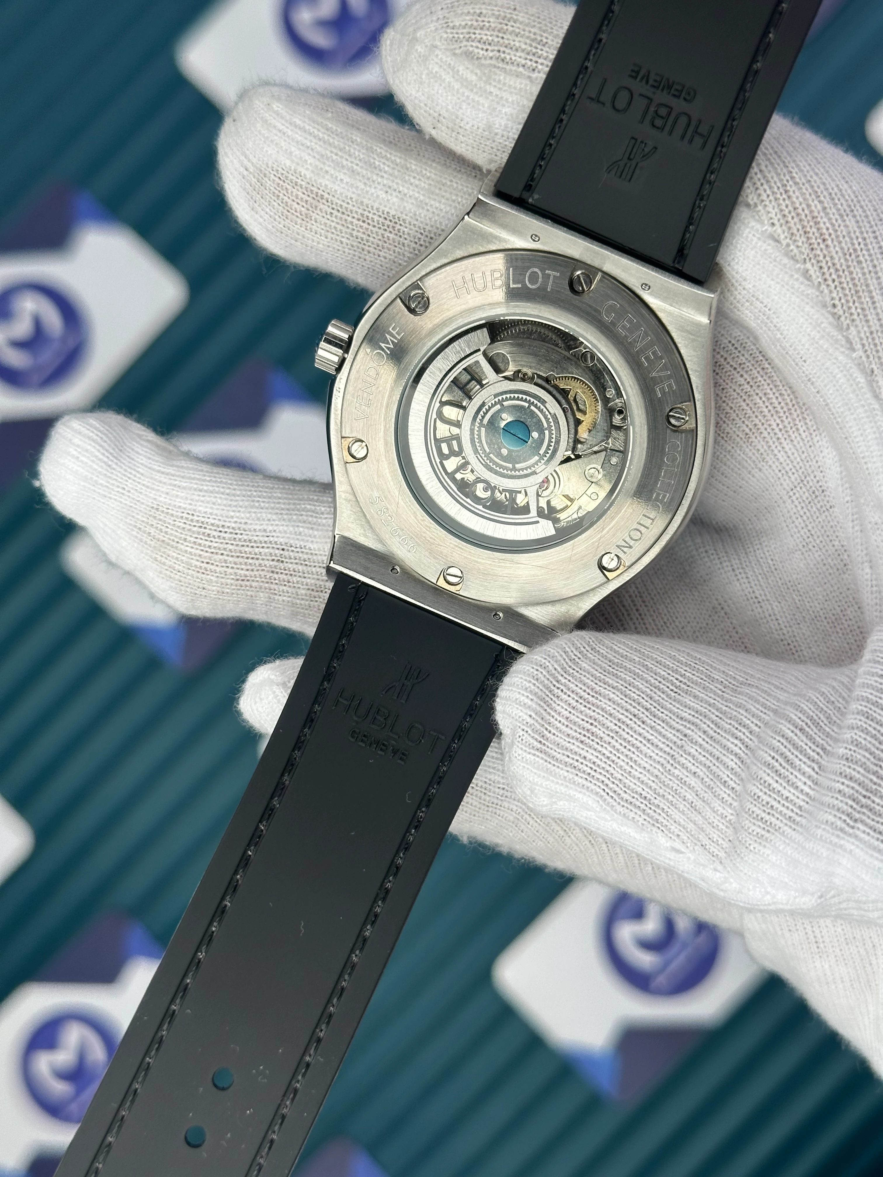 HUBLOT GENEVE AUTOMATIC BLACK DIAL SILVER CASE BLACK BEZEL BLACK LEATHER CORD 