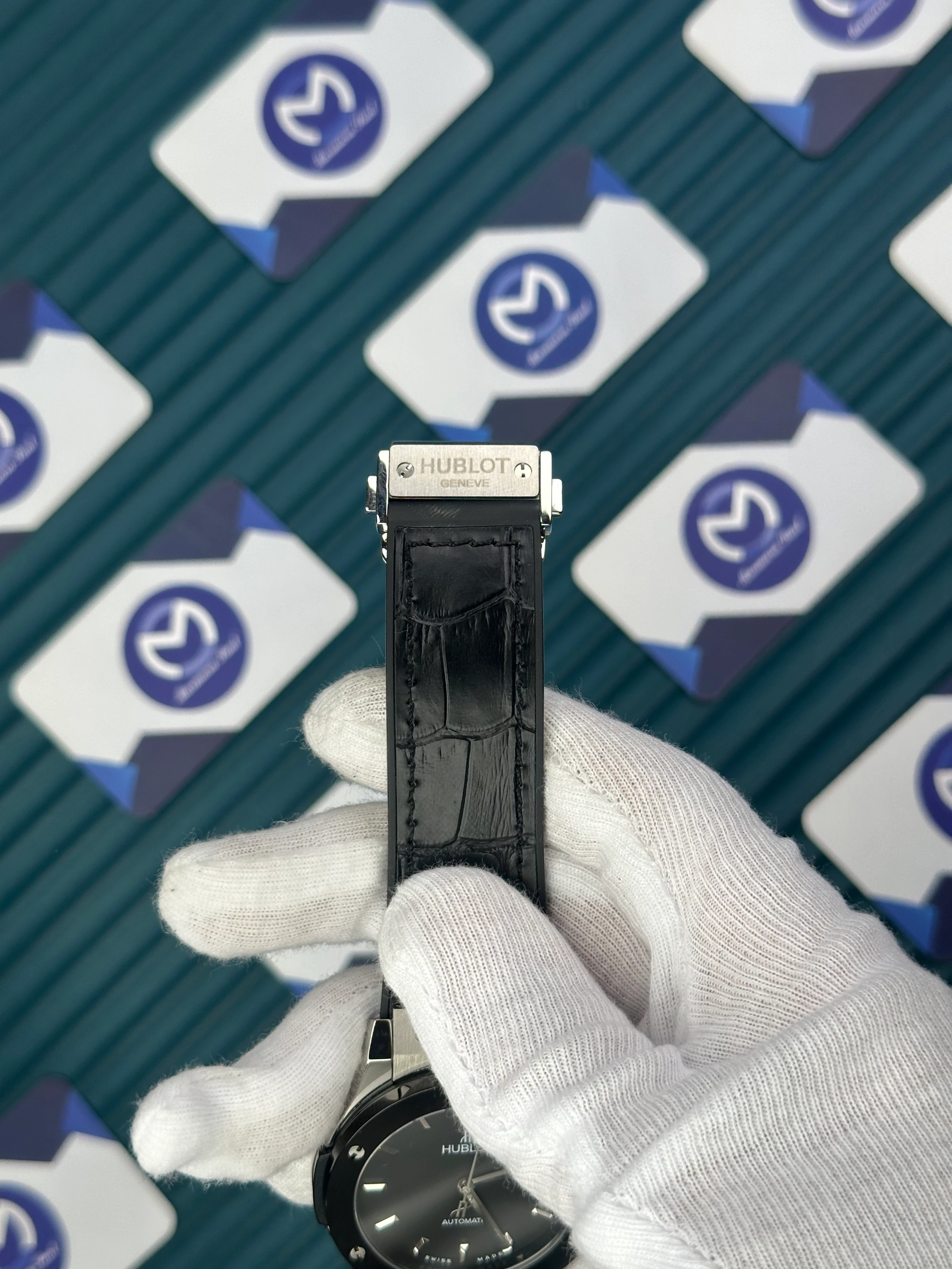 HUBLOT GENEVE AUTOMATIC BLACK DIAL SILVER CASE BLACK BEZEL BLACK LEATHER CORD 