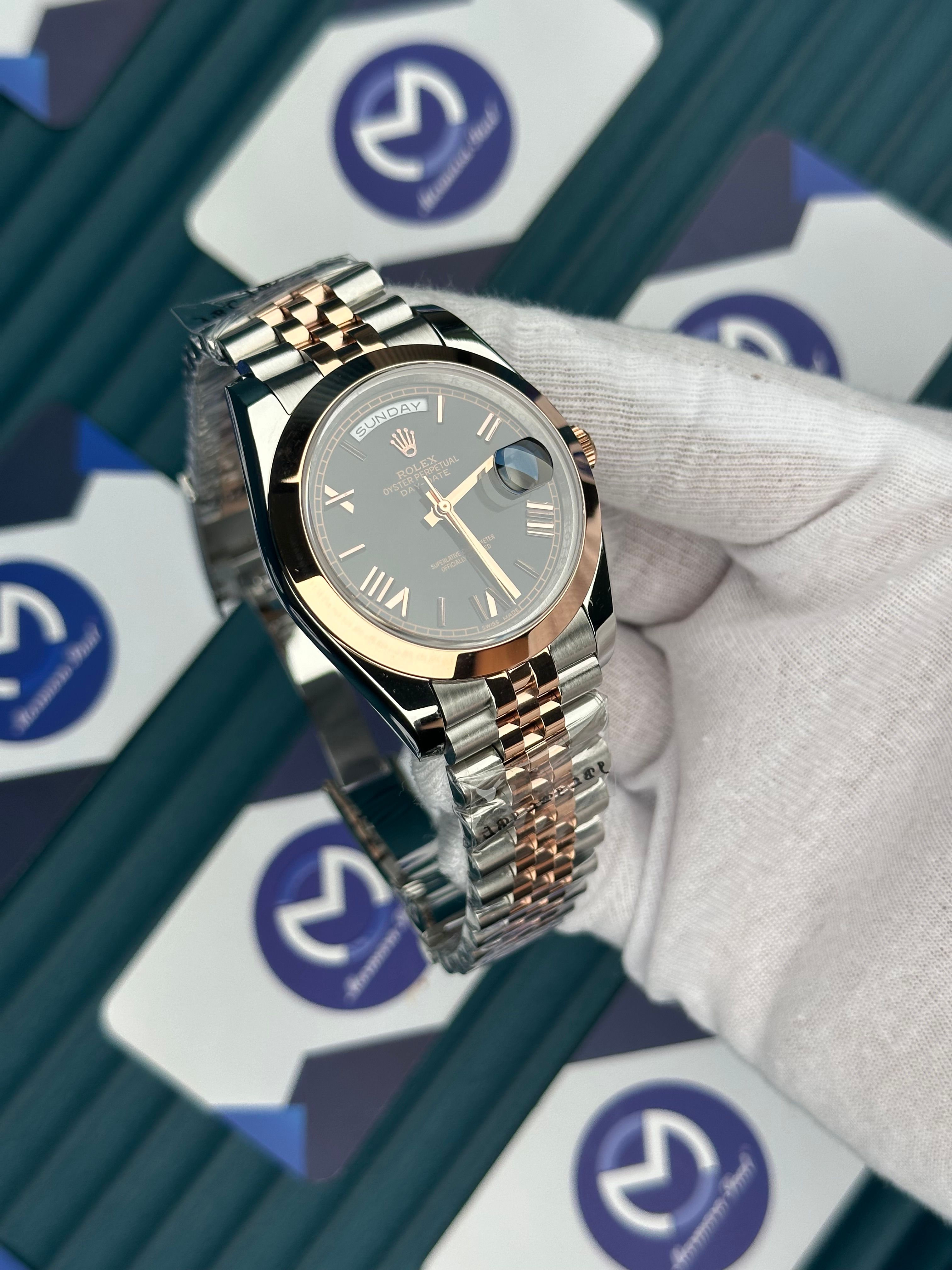 ROLEX DAY-DATE BLACK DIAL OVAL BEZEL ROMA INDEX ROSE-SILVER JUBILE