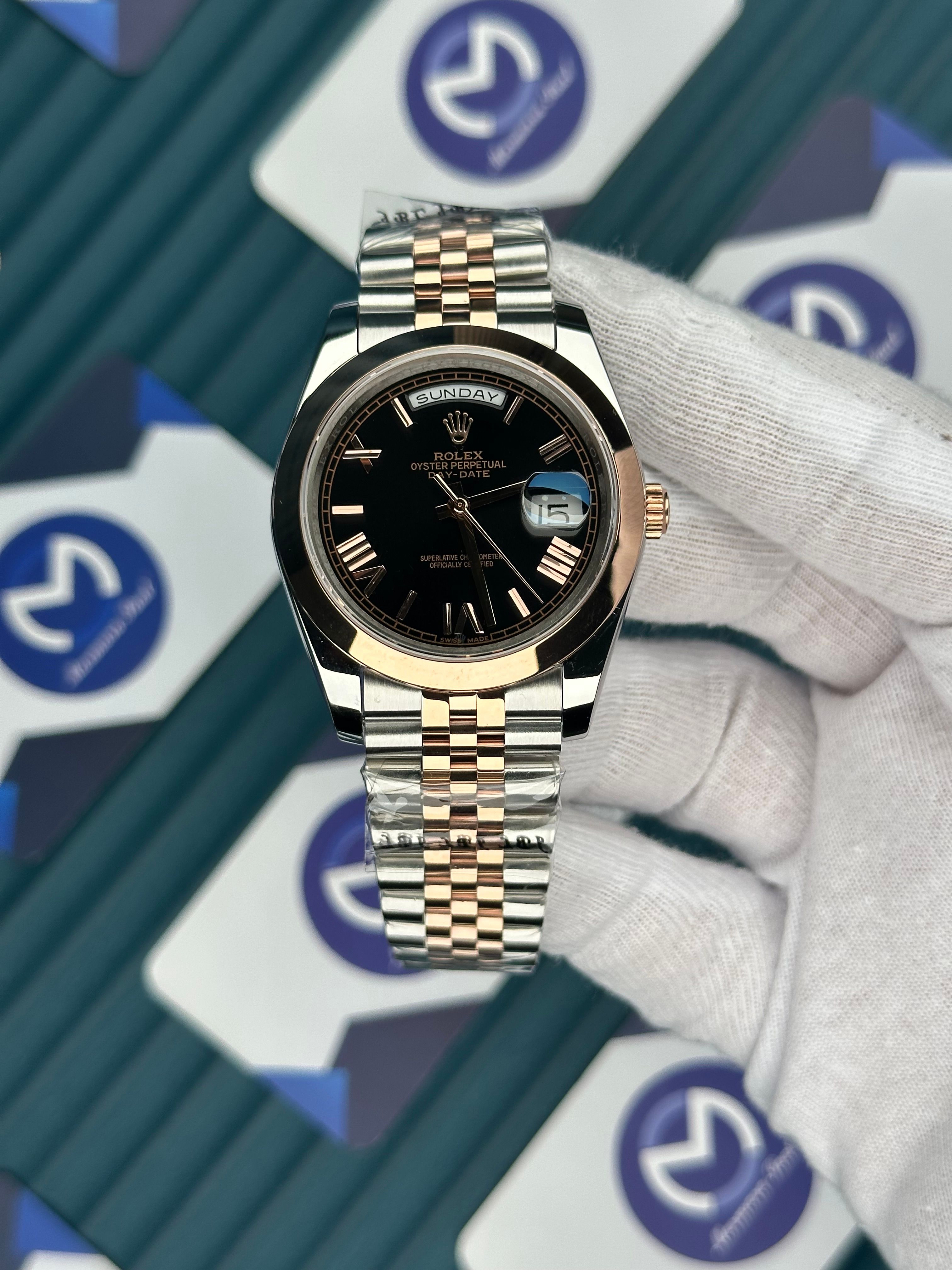 ROLEX DAY-DATE BLACK DIAL OVAL BEZEL ROMA INDEX ROSE-SILVER JUBILE