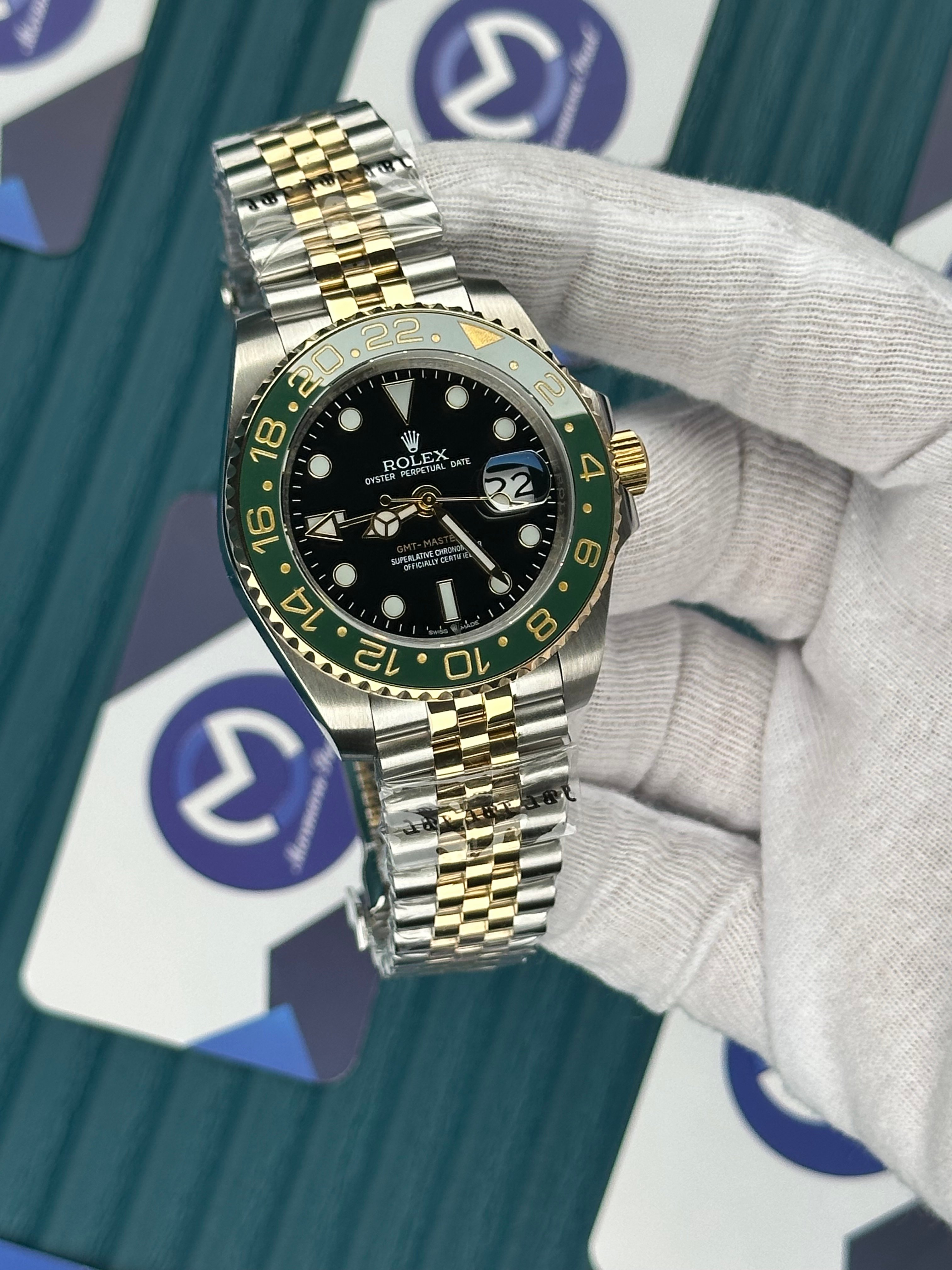 ROLEX GMT MASTER II BLACK DIAL GREEN BEZEL GOLD-SILVER JUBILE