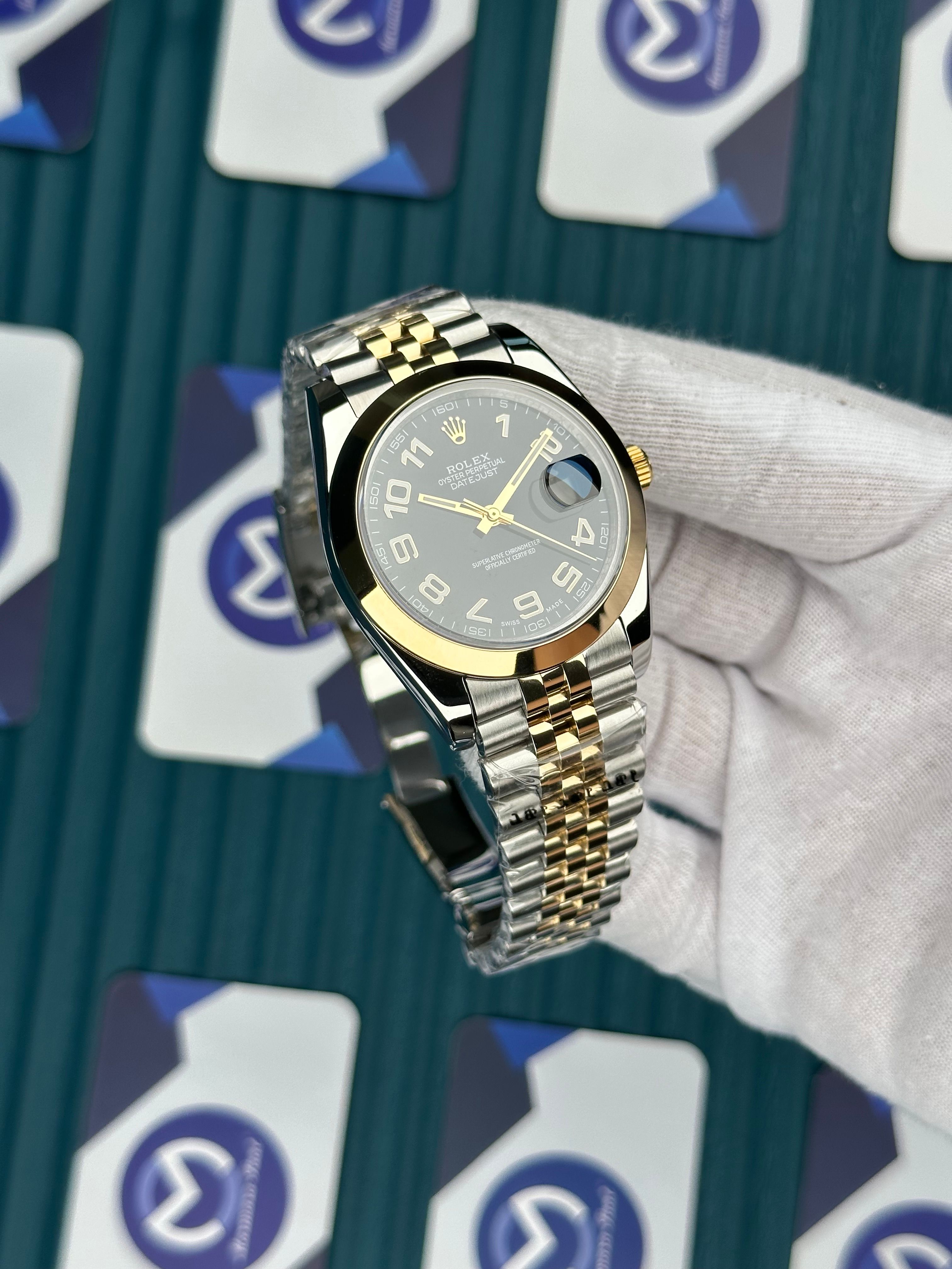 ROLEX DAY-DATE OVAL BEZEL BLACK DIAL LATIN INDEX GOLD-SILVER JUBILE