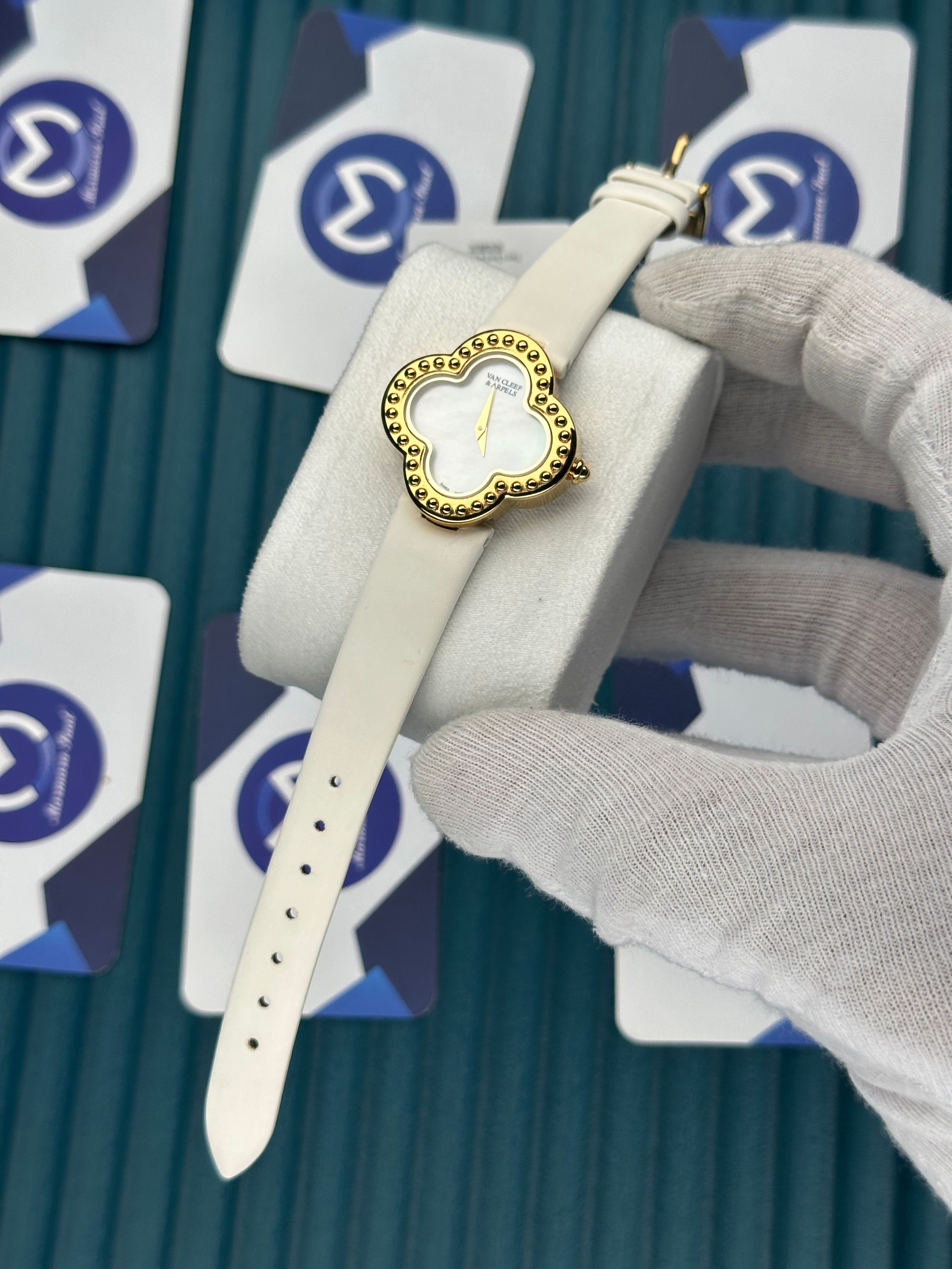 VAN CLEEF & ARPELS WHITE DIAL DIAMOND BEZEL GOLD CASE WHITE LEATHER CORD