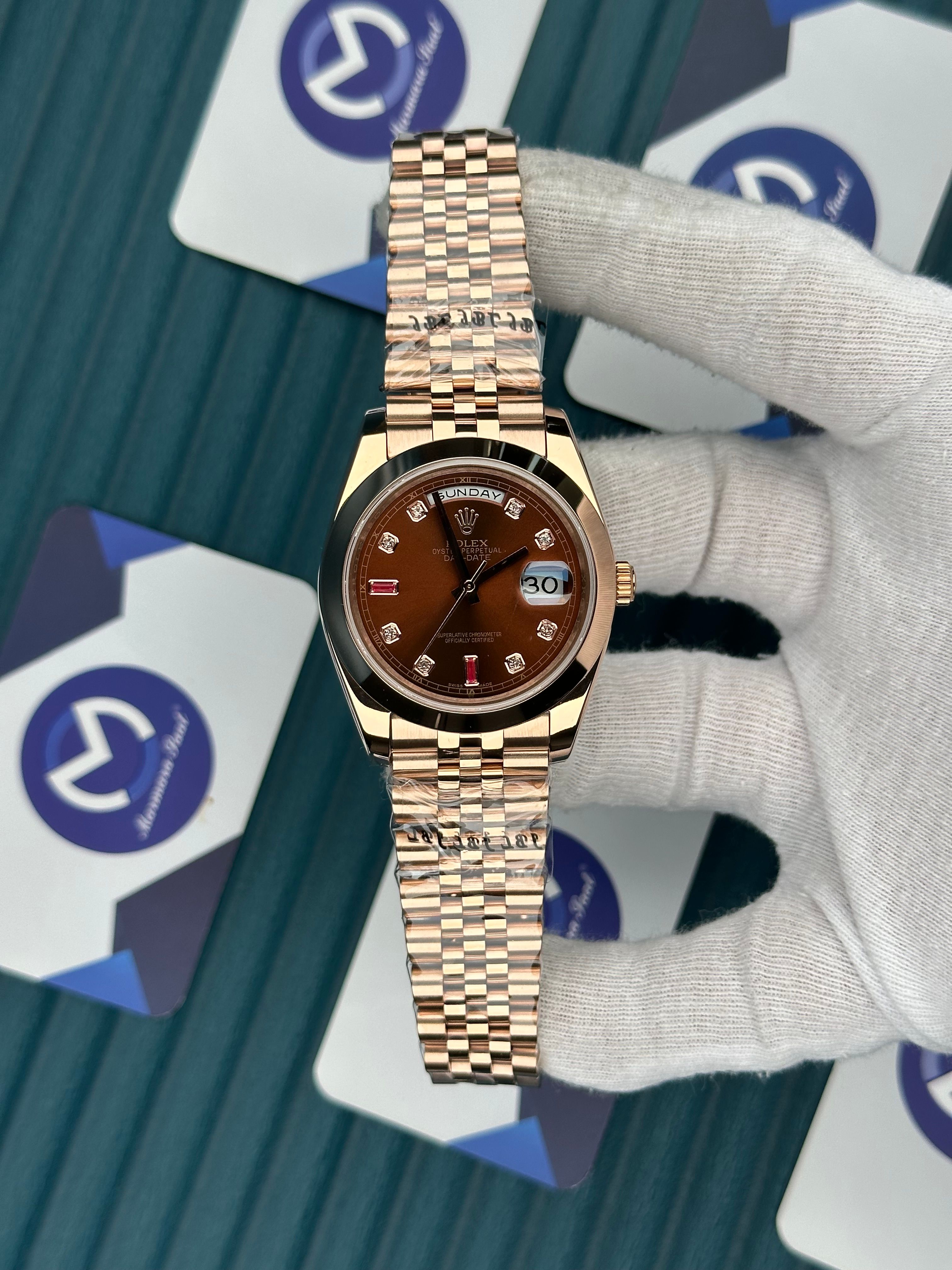 ROLEX DAY-DATE CHOCOLATE DIAL OVAL BEZEL DIAMOND INDEX ROSE JUBILE