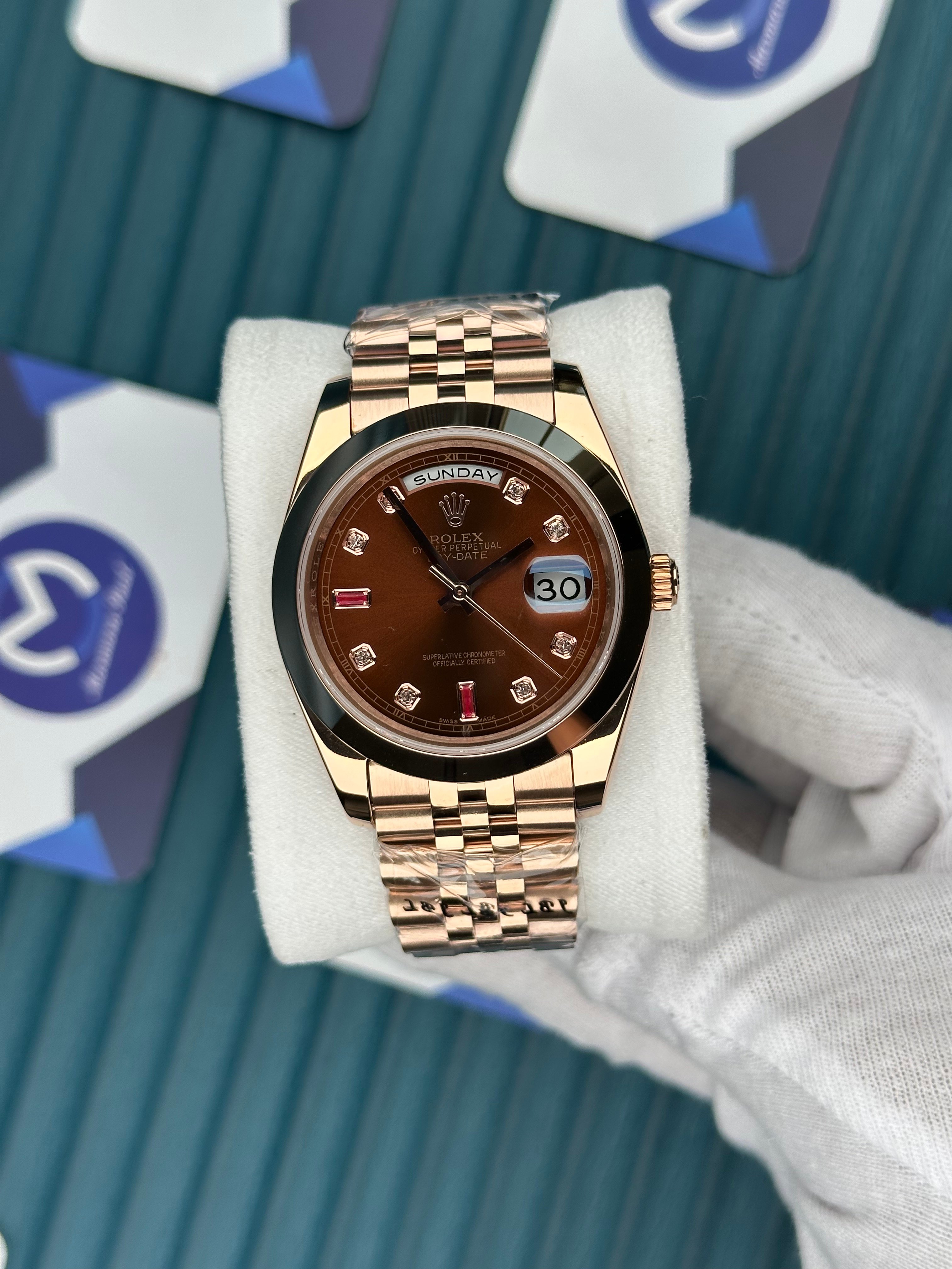 ROLEX DAY-DATE CHOCOLATE DIAL OVAL BEZEL DIAMOND INDEX ROSE JUBILE