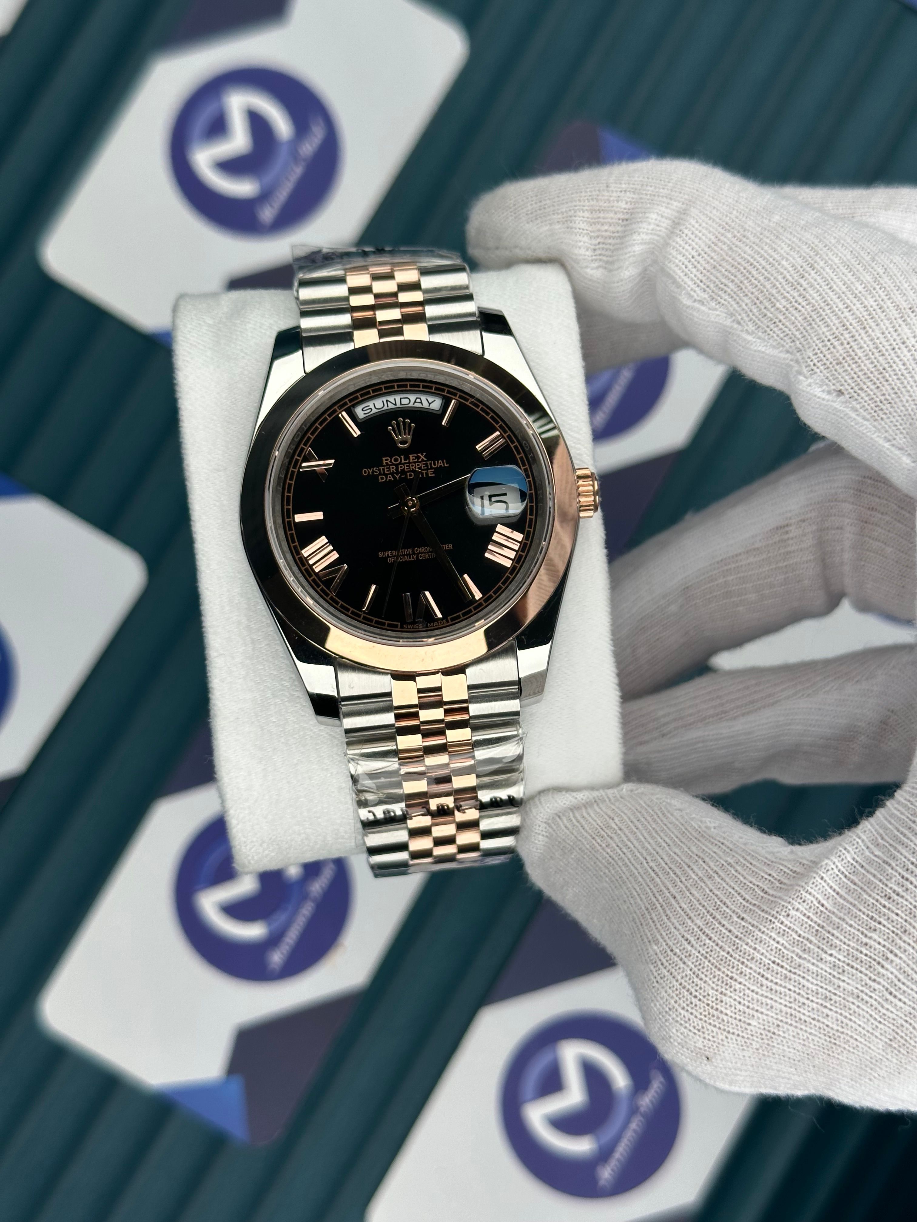 ROLEX DAY-DATE BLACK DIAL OVAL BEZEL ROMA INDEX ROSE-SILVER JUBILE