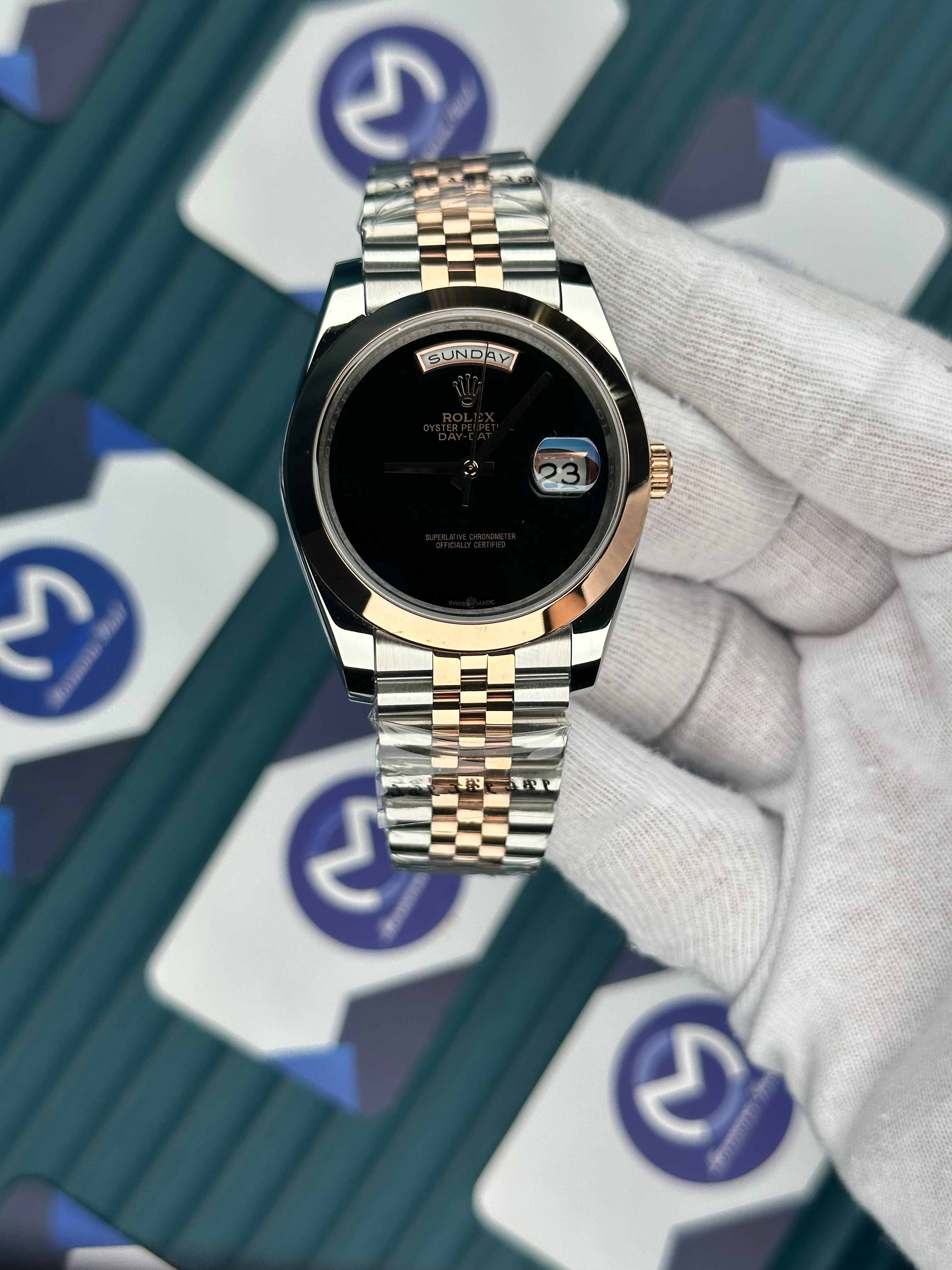 ROLEX DAY-DATE BLACK DIAL NO INDEX OVAL BEZEL ROSE-SILVER JUBILE