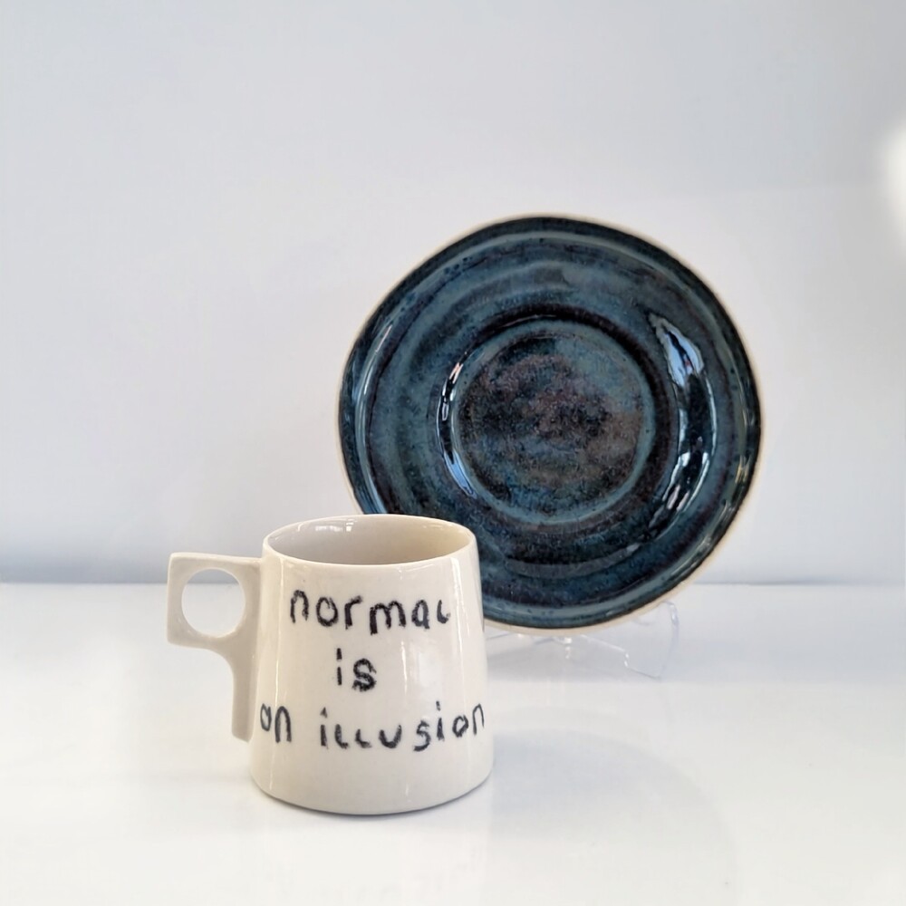 Stoneware Fincan " normal is an illusion"