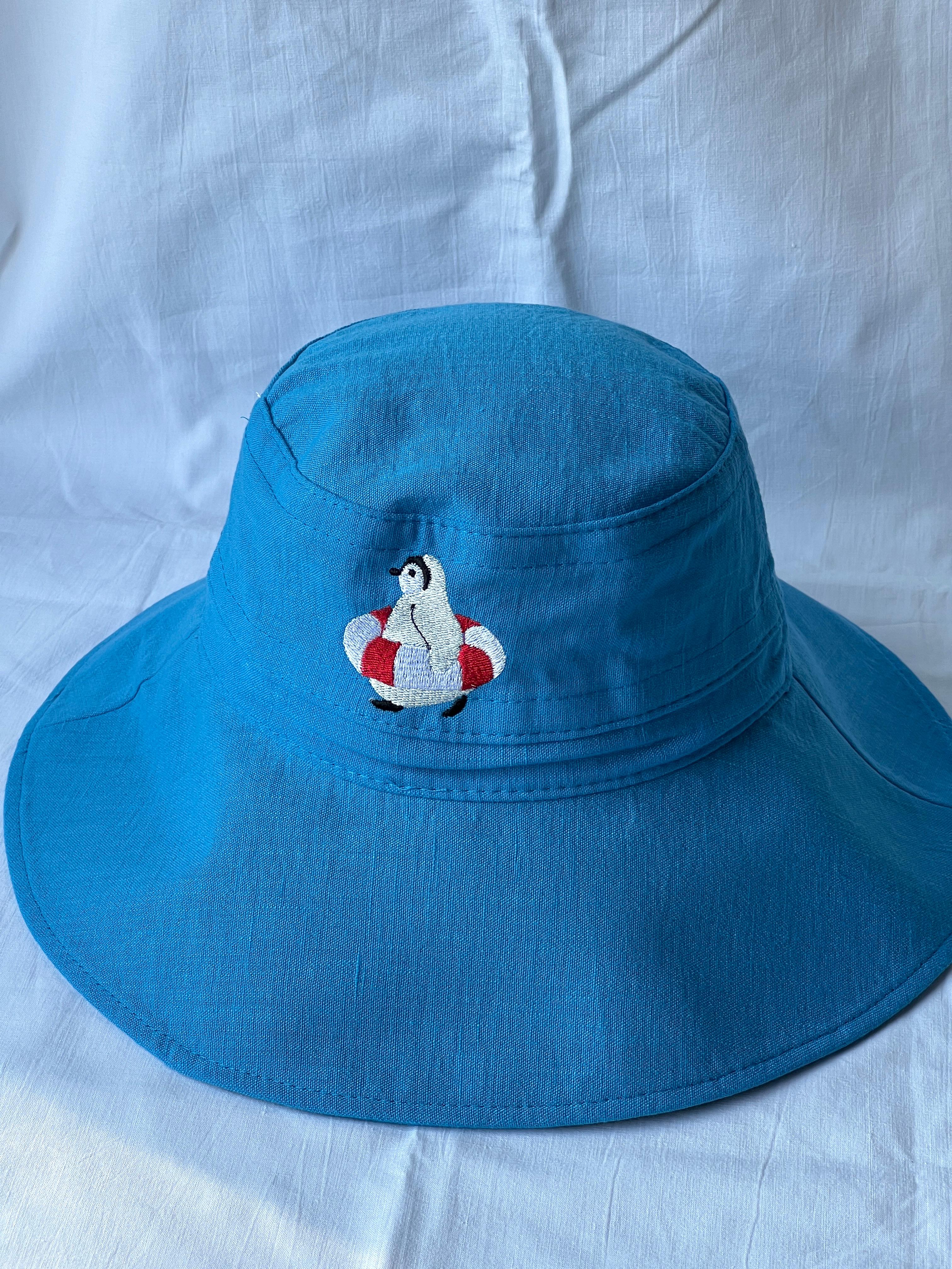 swimming penguin bucket hat