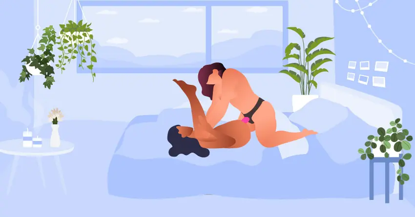 Yatakta misyoner pozisyonu: Sırt üstü yatan partner bacaklarını havaya kaldırırken, üstteki partner pembe strap-on dildo ile penetrasyon sağlıyor.