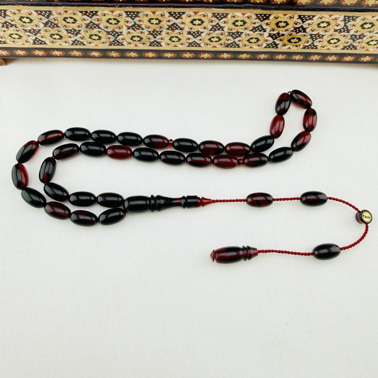 Usta İmzalı Kırmızı Siyah Hareli Sıkma Kehribar Tespih